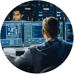 man viewing computer screens