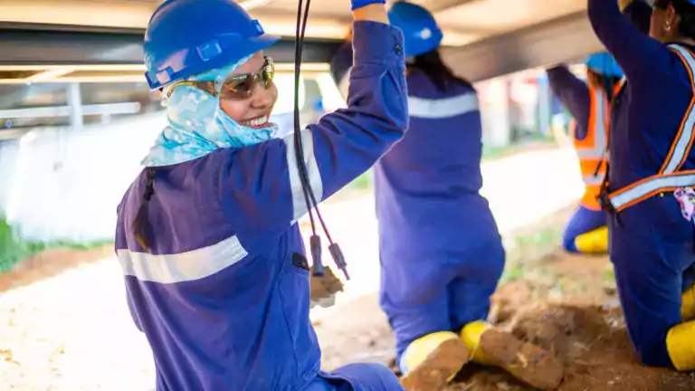 people - smiling worker in hard hat with others colombia