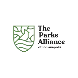 Logo for The Parks Alliance of Indianapolis featuring a green outlined shield with abstract nature elements and the organization name in bold black text.